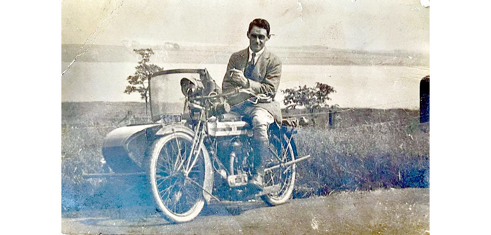 Old photo of Mark Carswells grandfather John Cowan Carswell on old motorbike by the shore