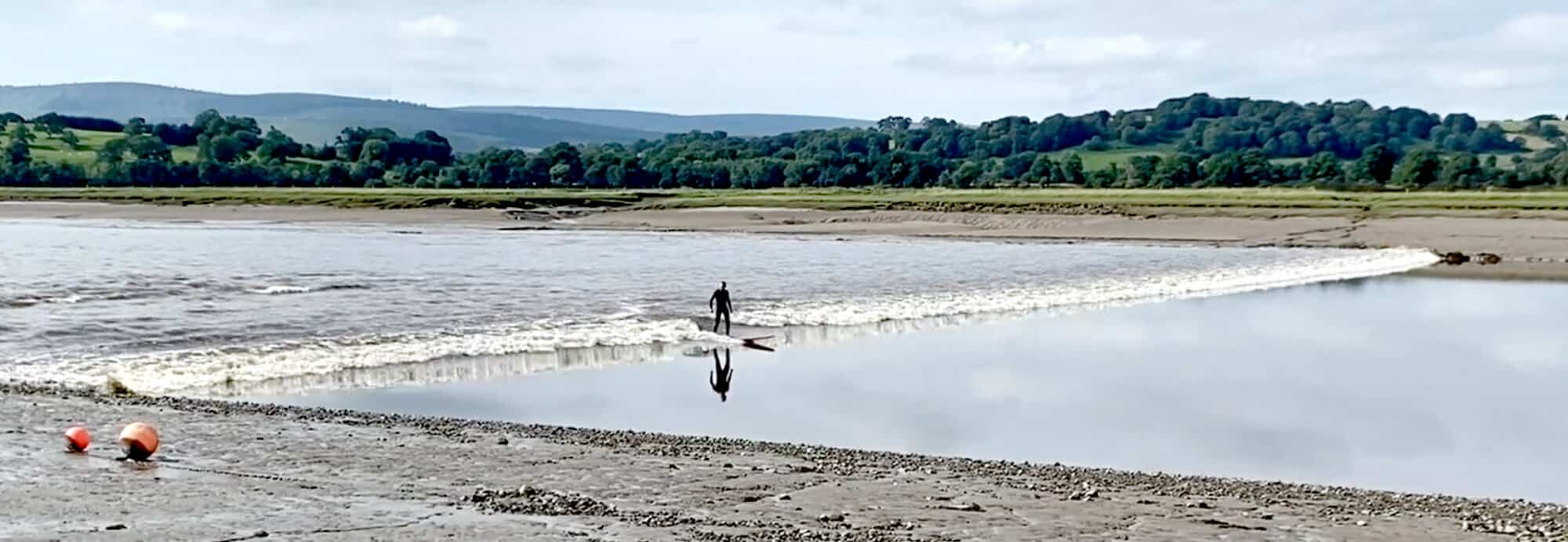 Photo of surfer on a tidal bore on the River Nith, Dumfries, Scotland