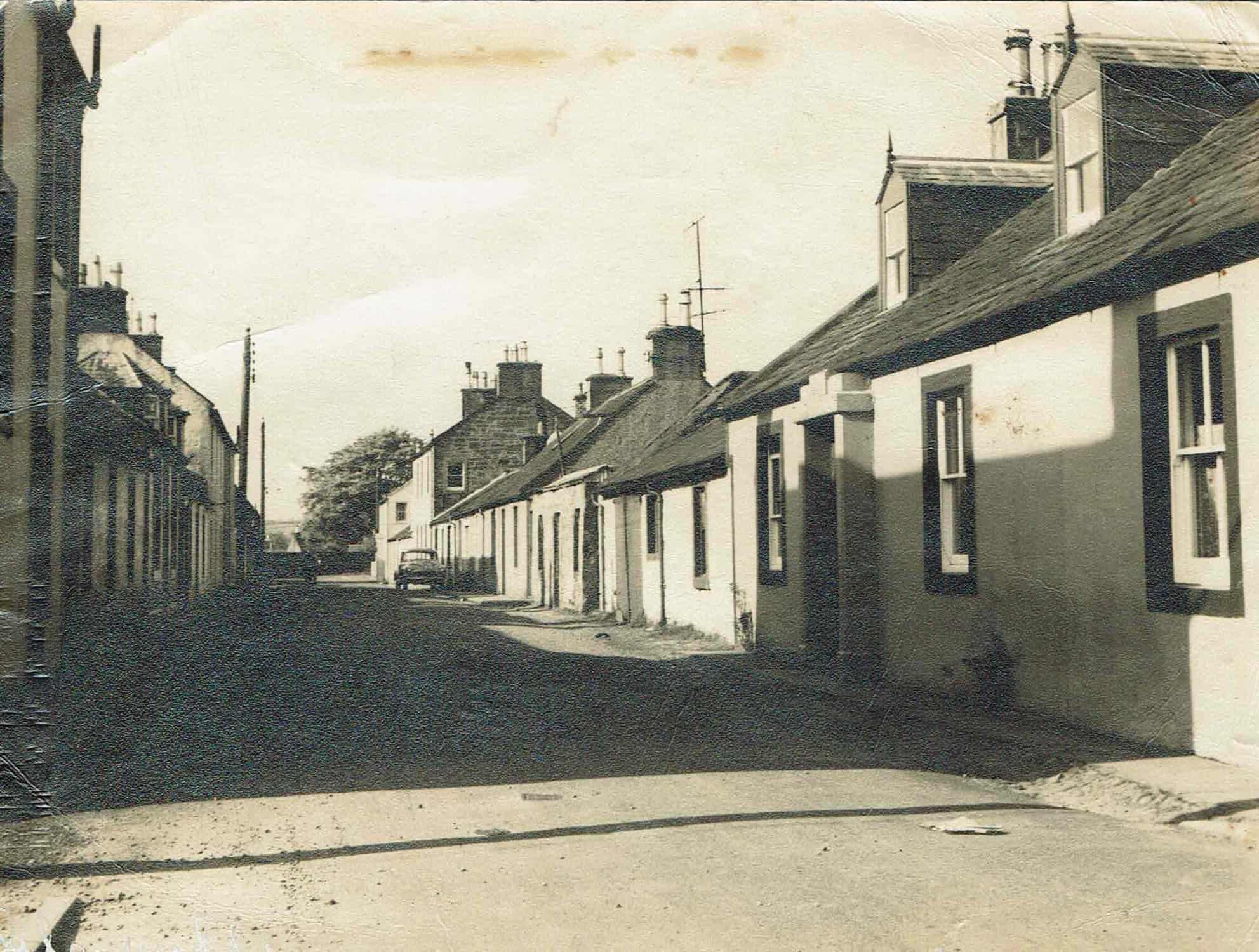 Old sepia and white photo of Wellington Street, Glencaple - only one car parked.